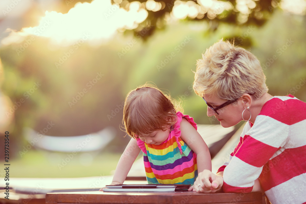 mom and her little daughter using tablet computer mom and her little daughter using tablet computer