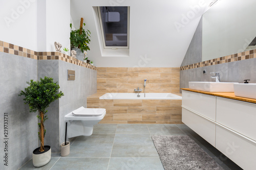 Fototapeta Naklejka Na Ścianę i Meble -  Modern bathroom interior with gray tiles and wooden decors