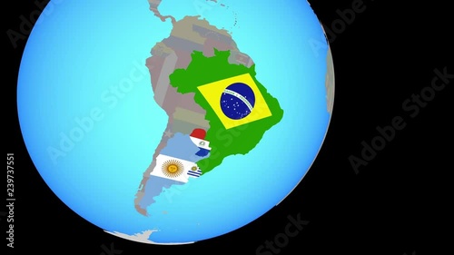 Zoom to Mercosur memebers with embedded national flags on blue political globe. 3D illustration.