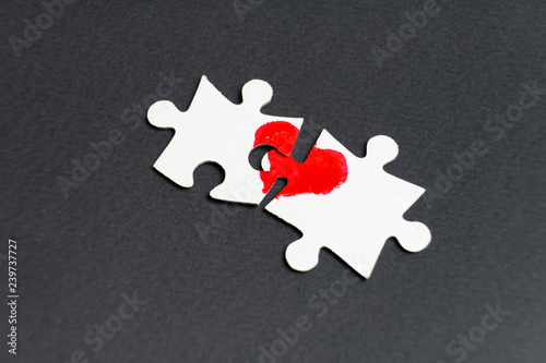 Symbol of love. Heart drawn on two puzzles.