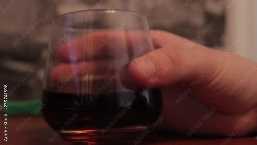 Glass of whiskey on a black and white wallpaper background.