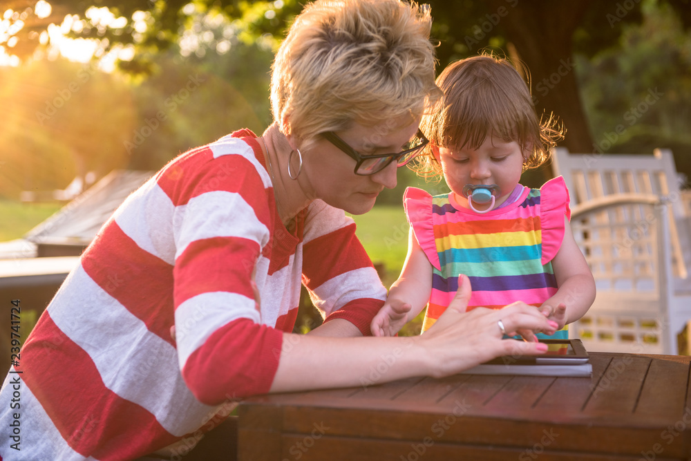 mom and her little daughter using tablet computer mom and her little daughter using tablet computer