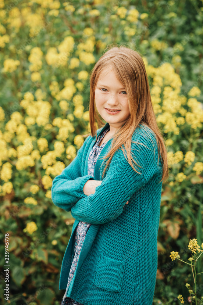 girl playing in yellow flowers field 