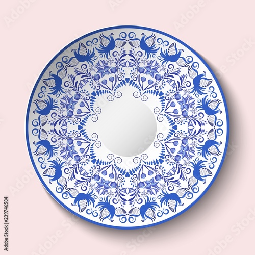 Patterned plate with blue ornament with birds and flowers in the style of national porcelain painting.