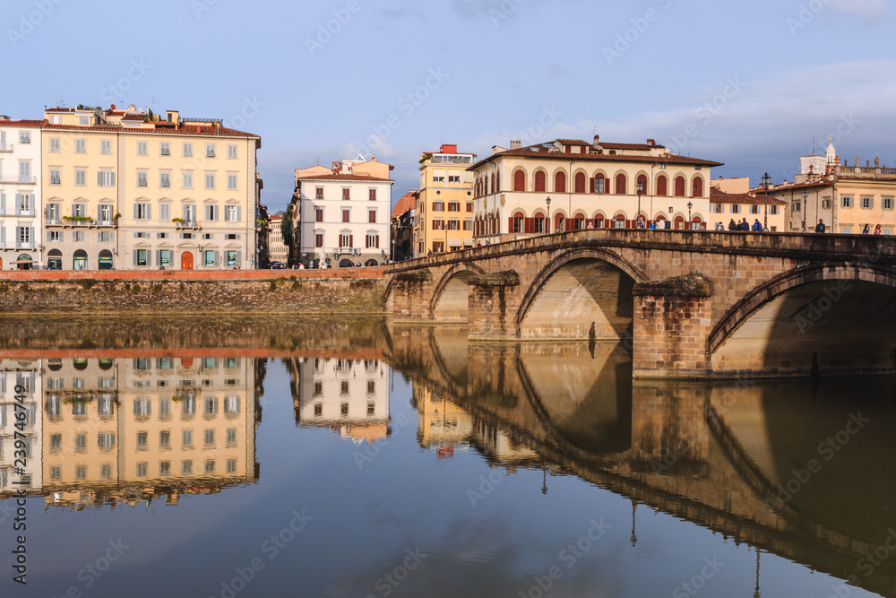 Old buildings reflecting in the Arno River in Florence. Houses with reflection in water Old buildings reflecting in the Arno River in Florence. Houses with reflection in water