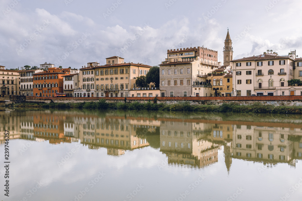 Old buildings reflecting in the Arno River in Florence. Travel destination in Italy, Europe.