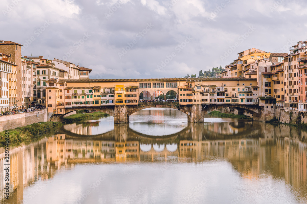 View of Ponte Vecchio in Florence (Firenze) in a cloudy day. Beautiful landscape of Florencia, Italy.