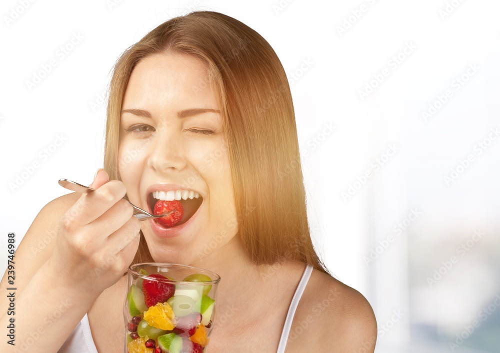 Attractive caucasian woman with fruit salad on background Attractive caucasian woman with fruit salad on background