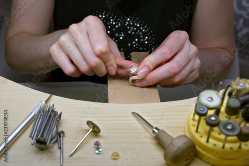 The profession of a jeweler. Close-up of the hands of a jeweller . Jewelry making. Handwork.