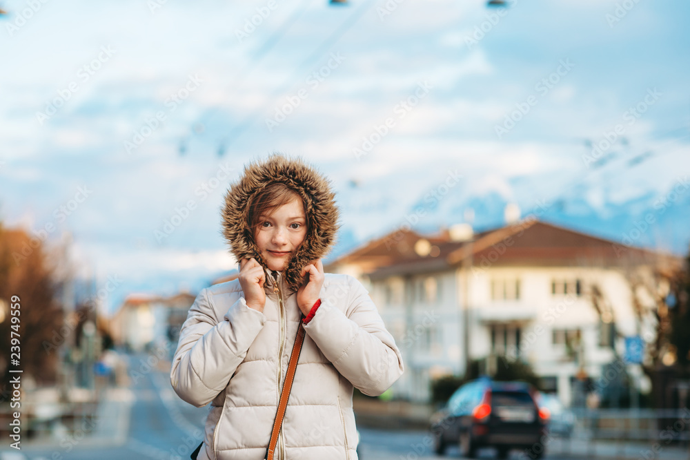 Outdoor portrait of cute little girl wearing warm winter jacket, image taken in Lausanne, Switzerland