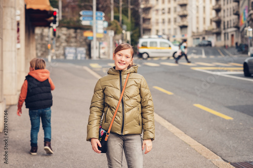 Outdoor portrait of two kids wearing warm jackets, spring fashion for children