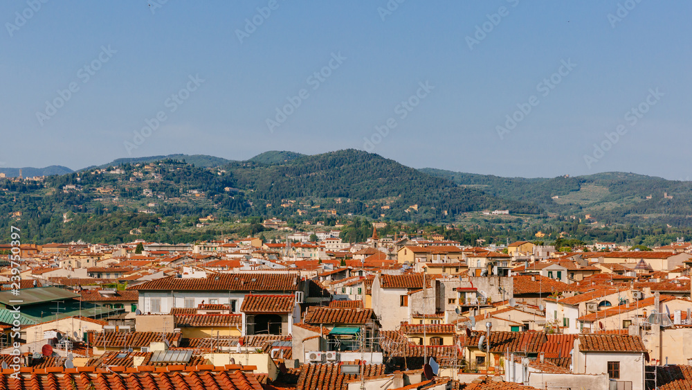 Houses and architecture of historical center of Florence, Italy under hills and sky