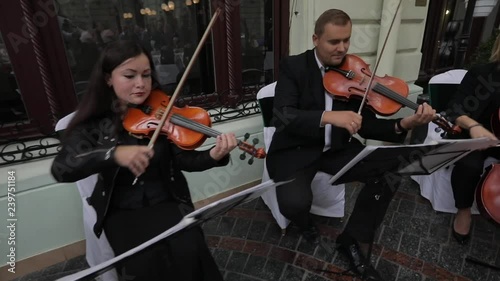 Violin concert. Musician playing violin outdoors. Violinist play music for the wedding. Violin under the open sky. Wedding music concept