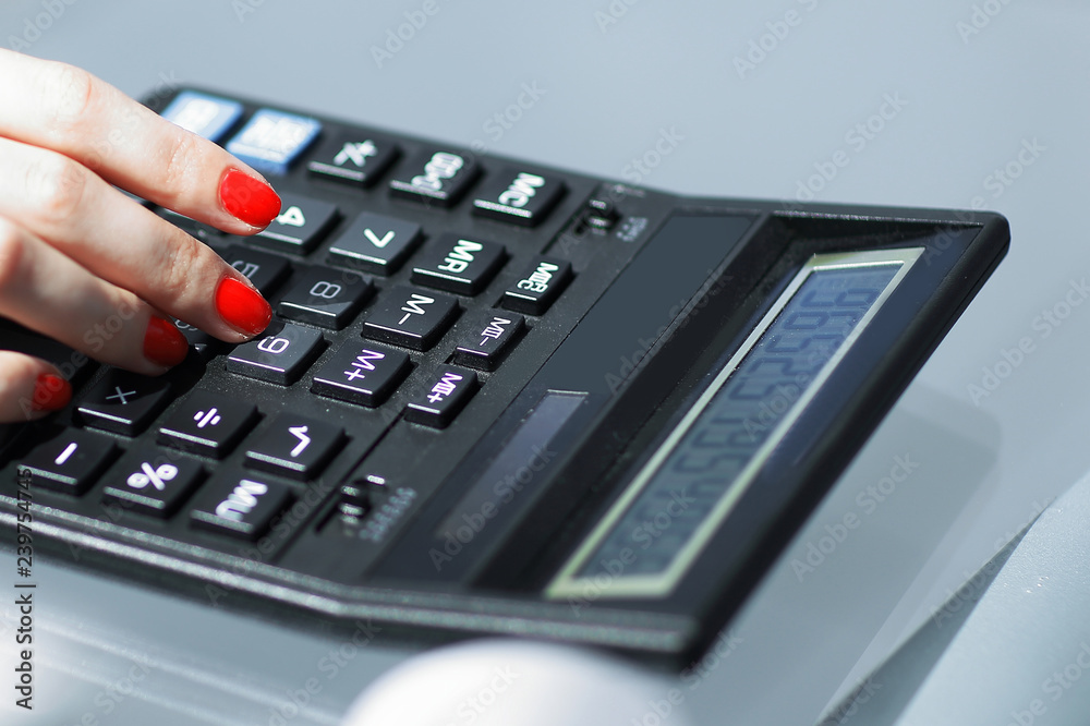 .closeup.business woman using a calculator at the workplace. .closeup.business woman using a calculator at the workplace.