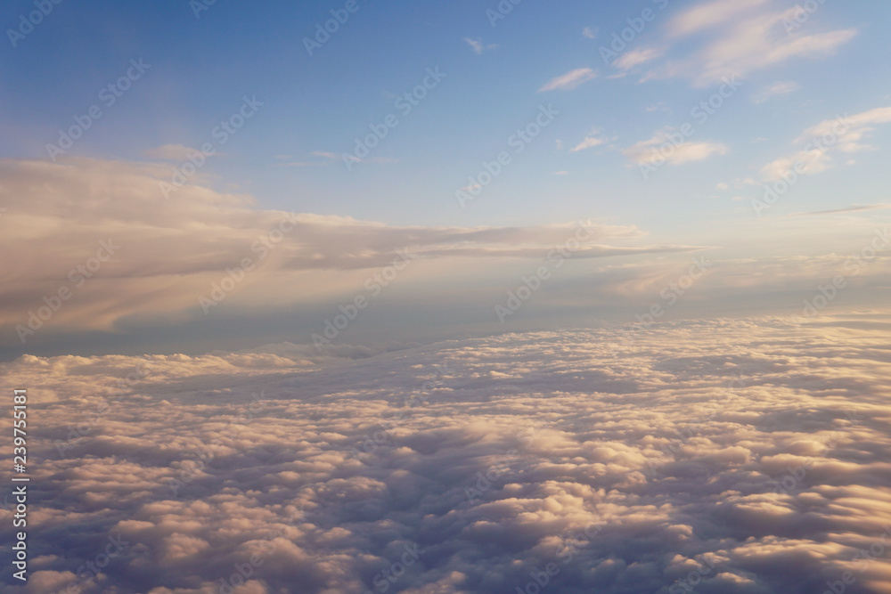 Sunset above the clouds landscape from an airplane journey Sunset above the clouds landscape from an airplane journey