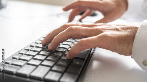 Low angle closeup view of male hands typing