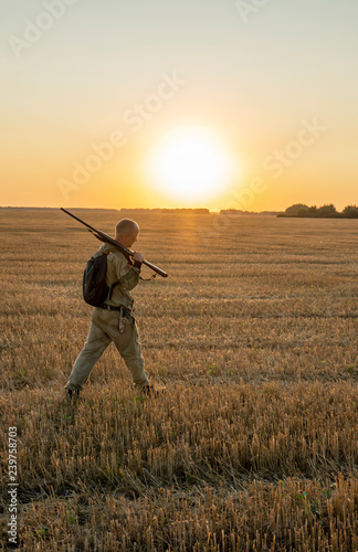 autumn hunting for field game with a dog at sunset