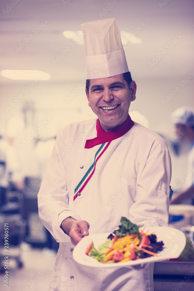 Chef showing a plate of tasty meal Chef showing a plate of tasty meal