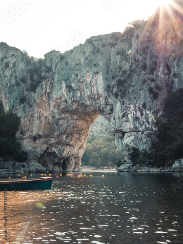 Natural Bridge Pont d'Arc and canoe in Southern France
