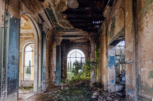 Fototapeta Naklejka Na Ścianę i Meble -  Ruined large hall interior overgrown by plants and moss
