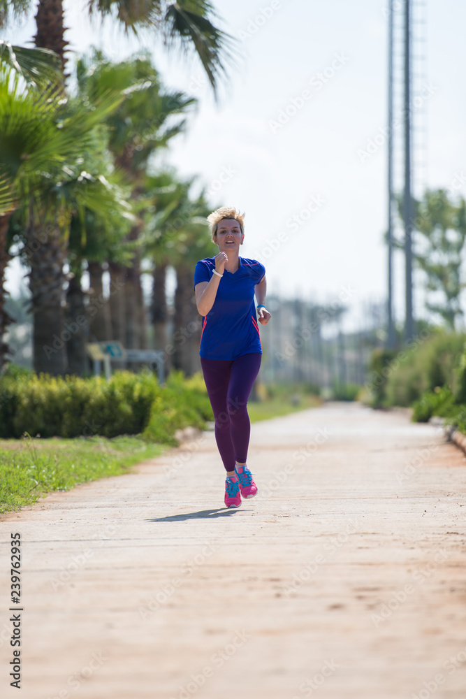 young female runner training for marathon