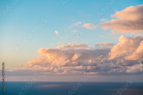 clouds over ocean, evening sky above ocean horizon 