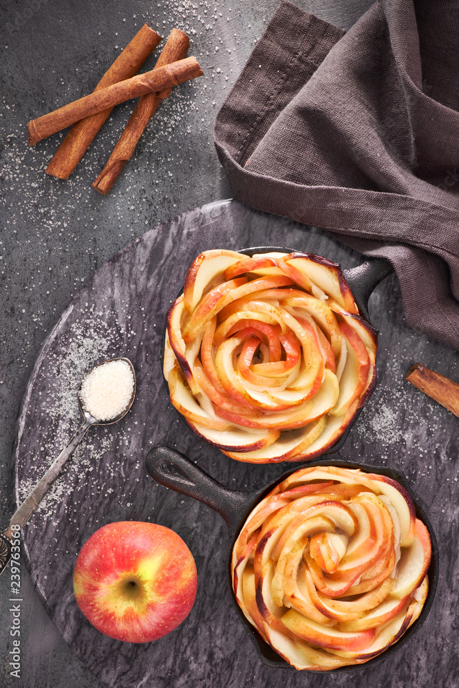 Homemade puff pastry with rose shaped apple slices baked in iron skillets Homemade puff pastry with rose shaped apple slices baked in iron skillets