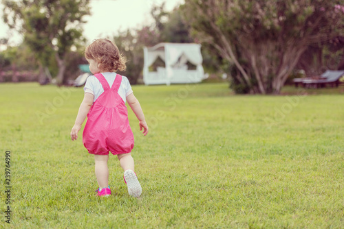 little girl spending time at backyard