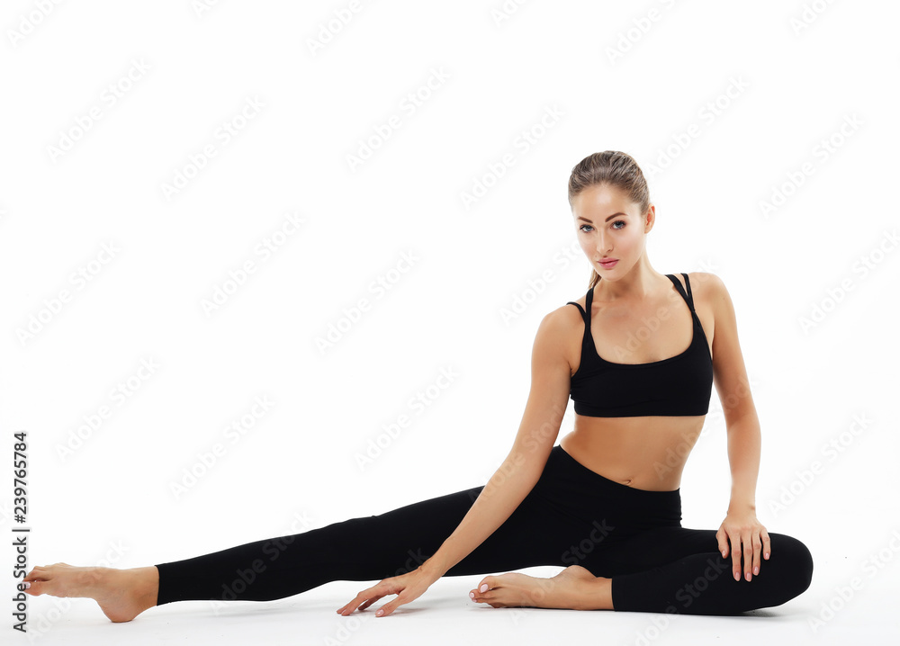 Young woman practicing yoga, working out, wearing sportswear, studio shoot over white background Young woman practicing yoga, working out, wearing sportswear, studio shoot over white background