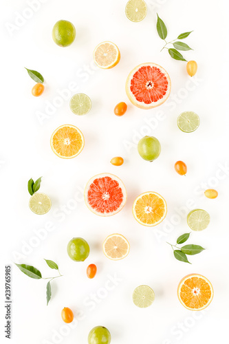 Fototapeta Naklejka Na Ścianę i Meble -  Creative pattern made of summer tropical fruits: grapefruit, orange, lemon, lime and leaves ficus. Food concept.  flat lay, top view