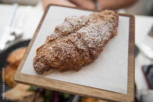 Image of very delicious and tasty baked croissant served at Ottolenghi restaurant in UK. The food seems to be very delicious and looks very fresh. photo