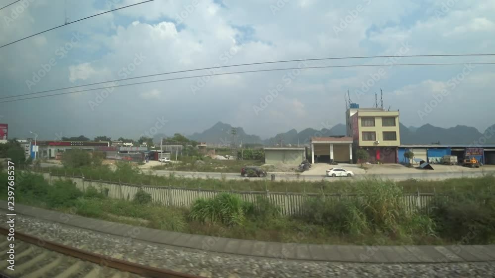 CHINA - CIRCA NOVEMBER 2018 : Scenery from CHINA RAILWAY HIGH-SPEED TRAIN (HEXIE HAO TRAIN) window. Between NANNING station to GUILIN station. CHINA - CIRCA NOVEMBER 2018 : Scenery from CHINA RAILWAY HIGH-SPEED TRAIN (HEXIE HAO TRAIN) window. Between NANNING station to GUILIN station.