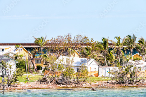 Many damaged, destroyed houses on beach by shore, coast in Florida keys, bridge after, aftermath of destruction of hurricane irma, houses after storm heavy wind photo