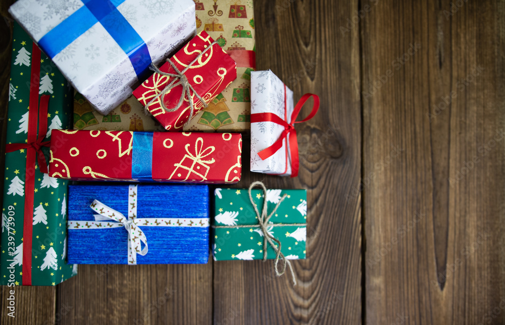 background. Gifts in festive color packaging, lie on a wooden floor. New Year, Christmas, Saint Nicholas, Santa. background. Gifts in festive color packaging, lie on a wooden floor. New Year, Christmas, Saint Nicholas, Santa.