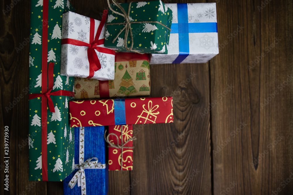 background. Gifts in festive color packaging, lie on a wooden floor. New Year, Christmas, Saint Nicholas, Santa. background. Gifts in festive color packaging, lie on a wooden floor. New Year, Christmas, Saint Nicholas, Santa.