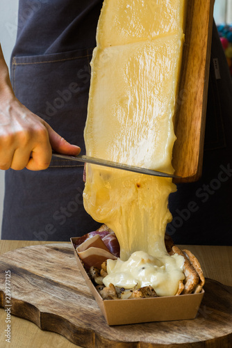 man pouring raclette cheese