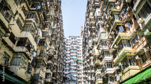 Famous building name Yick Fat Yick residentrial building at Cheong Fok Cheong in Quarry Bay, Hong Kong with urban housing apartment background. photo