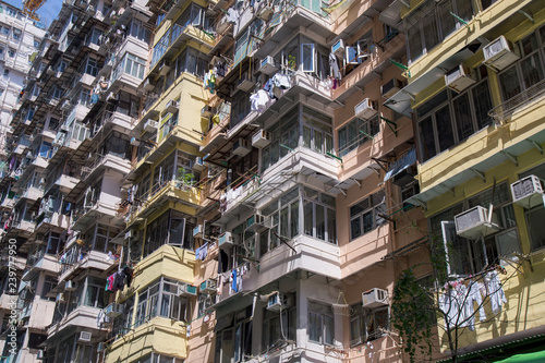 Famous building name Yick Fat Yick residentrial building at Cheong Fok Cheong in Quarry Bay, Hong Kong with urban housing apartment background. photo