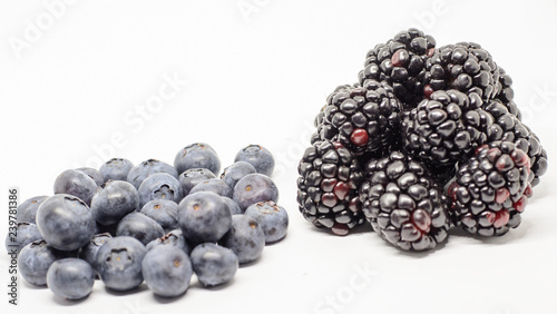six large berries of fresh blackberries and fifteen berries on a white background  blueberries