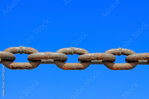 oxidation rusty chains under the blue sky