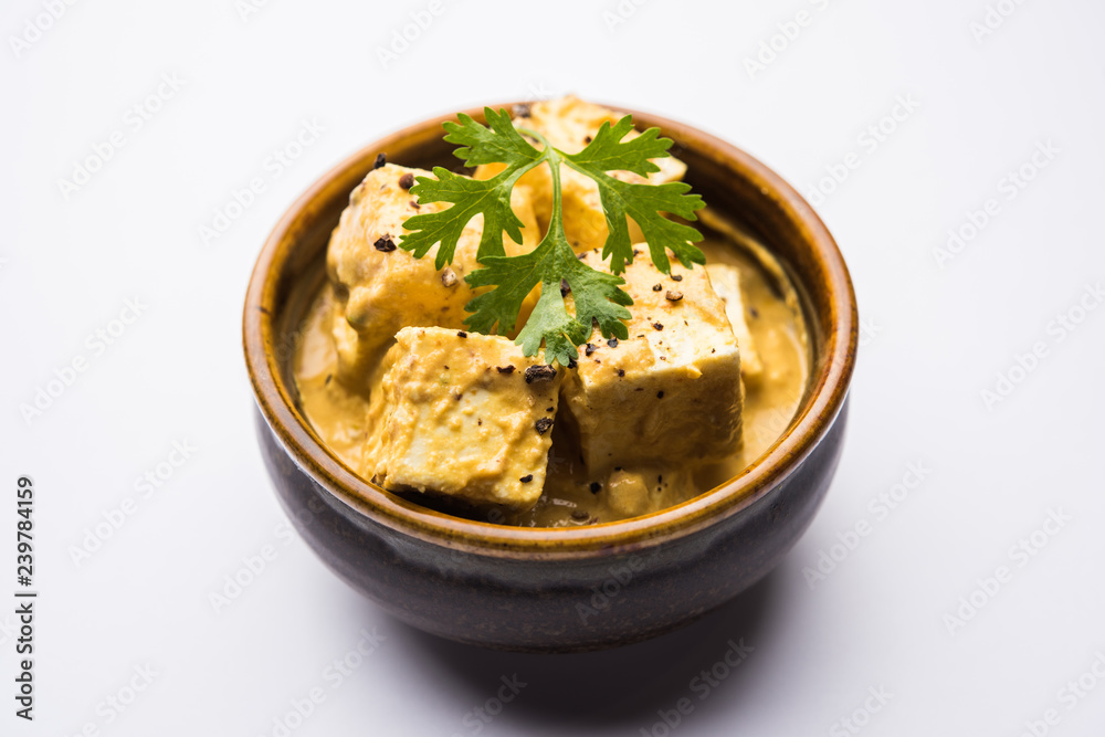 Malai or achari Paneer in a gravy made using Whipping Cream. served on a serving pan. selective focus Malai or achari Paneer in a gravy made using Whipping Cream. served on a serving pan. selective focus