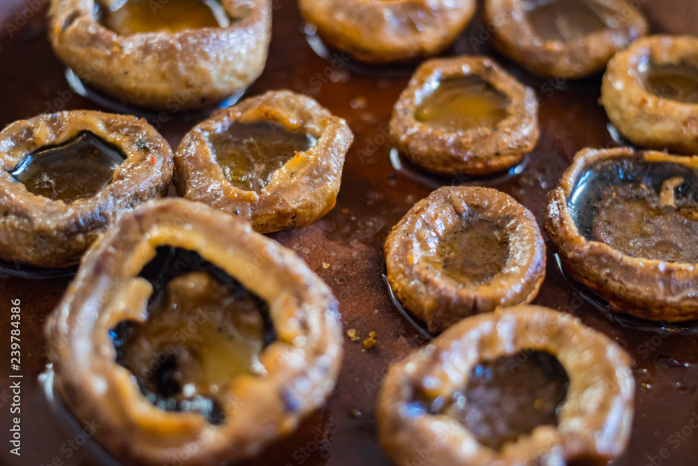 Roasted, baked mushrooms called Gryba in clay dish (ketsi - georgian traditional) with sunflower oil. Georgian traditional food. Roasted, baked mushrooms called Gryba in clay dish (ketsi - georgian traditional) with sunflower oil. Georgian traditional food.