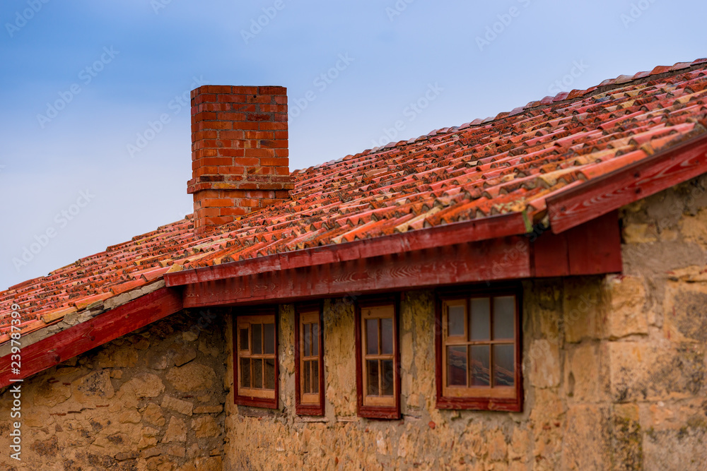 roof of a rural house close up against blue sky