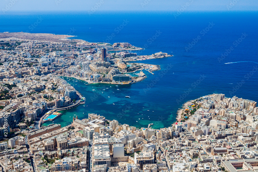 Malta aerial view. St. Julian's (San Giljan) and Tas-Sliema cities. St. Julian’s bay, Balluta bay, Spinola bay, Towns, harbours and coastline of Malta from above. Skyscraper in Paceville district