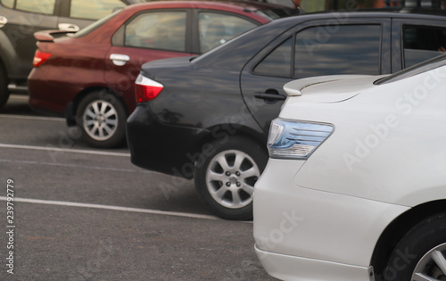 Closeup of rear side of white car parking in parking lot. © Amphon