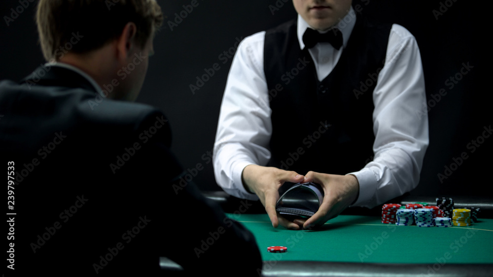 Experienced casino croupier making shuffling tricks with cards, chance to win Experienced casino croupier making shuffling tricks with cards, chance to win