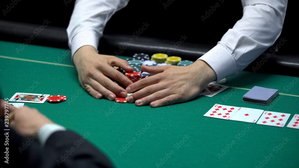 Sad casino player losing poker game, professional croupier taking all chips  Stock Photo | Adobe Stock