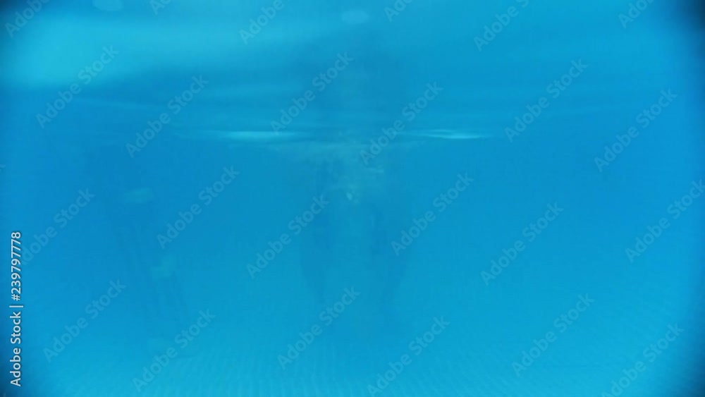 Water rehabilitation procedure with child with cerebral palsy. The kid dives into the water Water rehabilitation procedure with child with cerebral palsy. The kid dives into the water