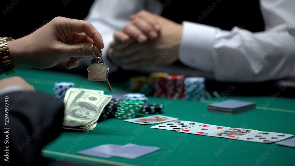 Confident businessman poker player betting all property in risky game, gambling Confident businessman poker player betting all property in risky game, gambling