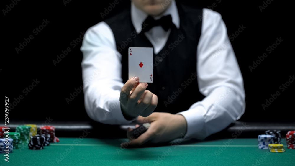 Αυτοκόλλητο Casino croupier showing ace card in front of camera, poker game shuffling tricks